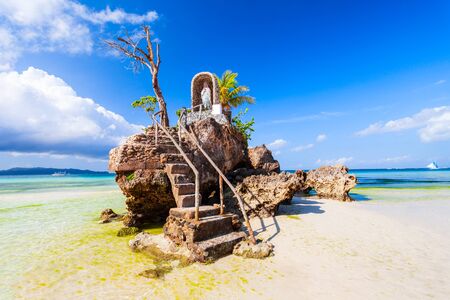 Willys Rock is a tidal island with a statue of the Virgin Mary at the Boracay beach in Philippinesの写真素材