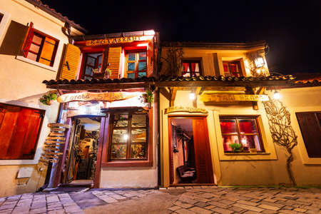 BAR, MONTENEGRO - MAY 25, 2013: Cafe and restaurant at the main street of Stari Grad Bar or Old Town Bar, a small town in Montenegro at nightのeditorial素材
