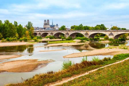 Orleans cathedral and bridge through Loire river. Orleans is a prefecture and commune in north central France.の写真素材