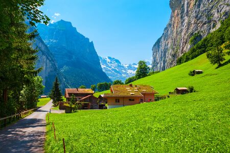 Traditional local houses in Lauterbrunnen valley in the Interlaken district in the Bern canton of Switzerlandの写真素材