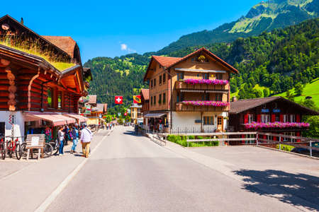 LAUTERBRUNNEN, SWITZERLAND - JULY 14, 2019: Traditional local houses in Lauterbrunnen village in the...