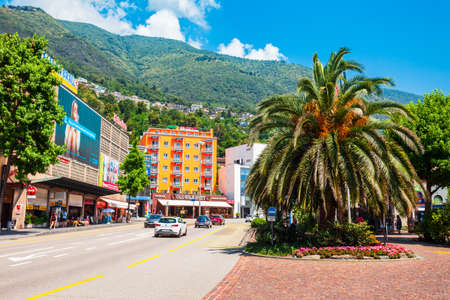 LOCARNO, SWITZERLAND - JULY 10, 2019: Street cafe and colorful houses in Locarno town on the shore of Lake Maggiore in the Ticino canton in Switzerland.のeditorial素材