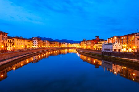 Colorful houses at the Arno river waterfront in the centre of Pisa city in Tuscany, Italyの写真素材