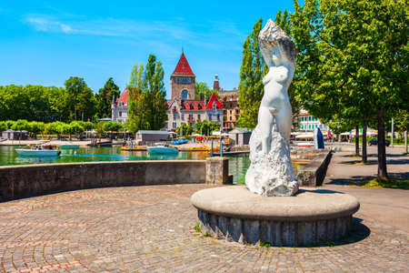 Sculpture La Vierge du Lac or Virgin of the Lake and Chateau d'Ouchy or Castle of Ouchy, an old medieval castle in Lausanne city in Switzerlandのeditorial素材