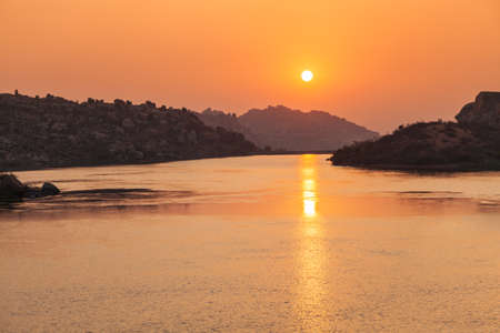 Mountain with boulders and river at Hampi, the centre of the Hindu Vijayanagara Empire in Karnataka state in Indiaの写真素材