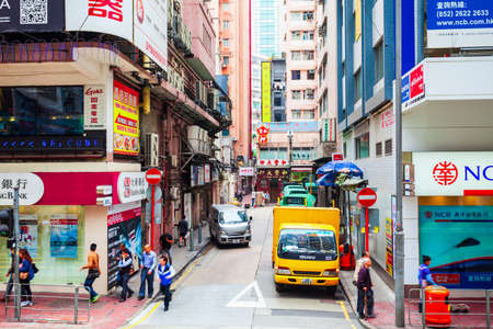 HONG KONG - FEBRUARY 22, 2013: Signboards with advertisement on a small shopping street in Hong...