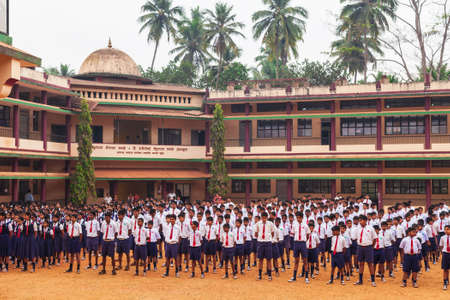 GOA, INDIA - FEBRUARY 28, 2012: Schoolboys meeting near the school building in India