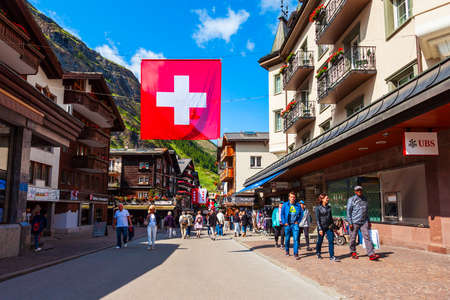 ZERMATT, SWITZERLAND - JULY 15, 2019: Traditional local houses in the centre of Zermatt town in the Valais canton of Switzerlandのeditorial素材