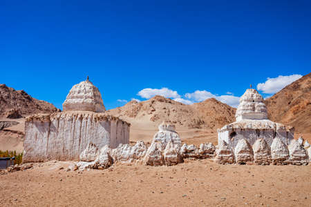 White stupas at the Shey Monastery, a tibetan style buddhist monastery in Shey village near Leh in Ladakh, north Indiaの写真素材
