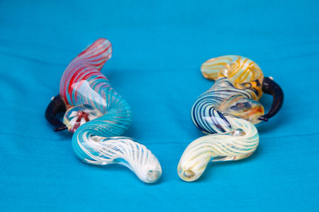 KATHMANDU, NEPAL - MAY 28, 2012: Exclusive design pipe for marijuana smoking on a blue fabric...