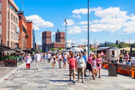 OSLO, NORWAY - JULY 20, 2017: Pedestrian promenade at the Aker Brygge waterfront in Oslo, Norway. Aker Brygge is a popular area for shopping, dining, and entertainment.のeditorial素材