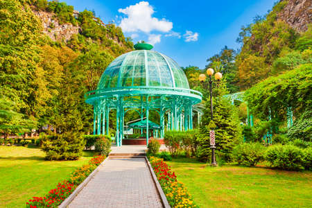Borjomi, Georgia - September 01, 2021: Glass pavilion above hot spring of mineral water in Borjomi central park. Borjomi is a resort town in Samtskhe Javakheti region of Georgia.のeditorial素材