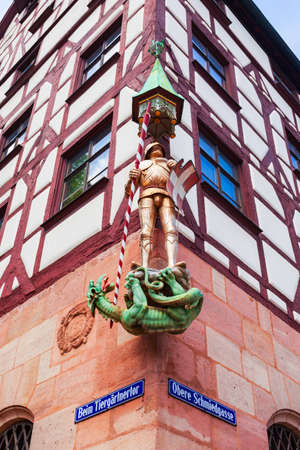 Nuremberg, Germany - July 10, 2021: Saint George slaying the dragon at the Pilatushaus or House of the Armored Man in Nuremberg old town, Bavaria state in Germany.のeditorial素材
