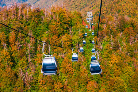 Cable car cabin rises up from Rosa Khutor village to Roza Peak mountain in Sochi resort city in Krasnodar Krai, Russiaの写真素材