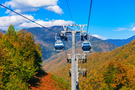 Cable car cabin rises up from Rosa Khutor village to Roza Peak mountain in Sochi resort city in Krasnodar Krai, Russiaの写真素材