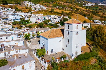 Our Lady of the Rosary Church aerial panoramic view in Bubion. Bubion is a village in the Alpujarras area in the province of Granada in Andalusia, Spain.の写真素材