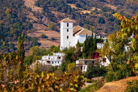 Our Lady of the Rosary Church aerial panoramic view in Bubion. Bubion is a village in the Alpujarras area in the province of Granada in Andalusia, Spain.の写真素材