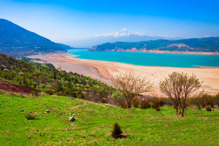 Lake Charvak or Chorvoq is a water reservoir in Chimgan region, Tian Shan or Tengri Tagh mountain range near Taskent city in Uzbekistanの写真素材