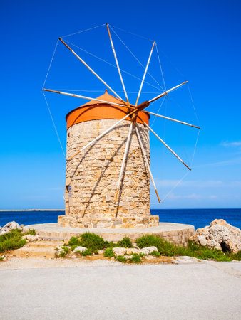 Windmills at the seafront in the city of Rhodes in Rhodes island in Greeceの写真素材