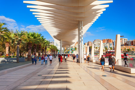 Malaga, Spain - October 23, 2021: Paseo del Muelle Uno boardwalk is a popular pedestrian promenade located in the centre of the city of Malagaのeditorial素材