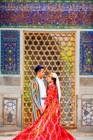 Samarkand, Uzbekistan - April 18, 2021: Bride and groom in traditional uzbek dresses at Registan ancient city, Samarkand city in Uzbekistanのeditorial素材