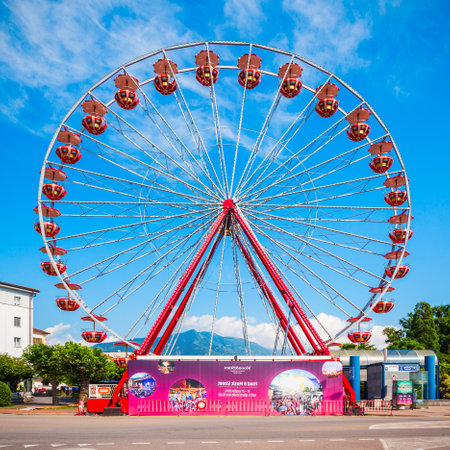 LOCARNO, SWITZERLAND - JULY 10, 2019: Ferris wheel in Locarno. Locarno is a town located on the shore of Lake Maggiore in the Ticino canton in Switzerland.のeditorial素材