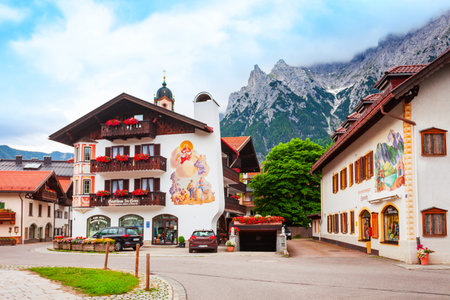 Mittenwald, Germany - July 01, 2021: Beauty local houses decorated with Luftlmalerei, bayern art form of facade painting in Mittenwald town in Bavaria, Germanyのeditorial素材