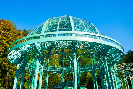 Borjomi, Georgia - September 01, 2021: Glass pavilion above hot spring of mineral water in Borjomi central park. Borjomi is a resort town in Samtskhe Javakheti region of Georgia.のeditorial素材