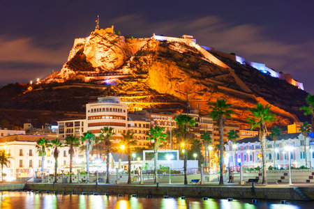 Port square and Santa Barbara Castle on background. Santa Barbara Castle is a fort stands on Mount Benacantil in the center of Alicante, Spain.のeditorial素材