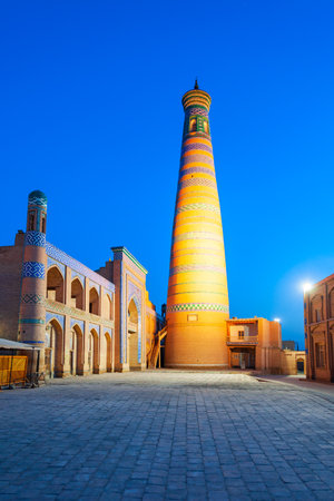 Islam Khodja Minaret at the Itchan Kala, the walled inner town of the city of Khiva in Uzbekistan at sunsetのeditorial素材