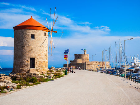 Windmills at the seafront in the city of Rhodes in Rhodes island in Greeceの写真素材