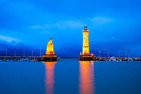 New Lindau Lighthouse and Bavarian Lion Sculpture at the Lindau harbor at night. Lindau is a major town and island on the Lake Constance or Bodensee in Bavaria, Germany.の写真素材