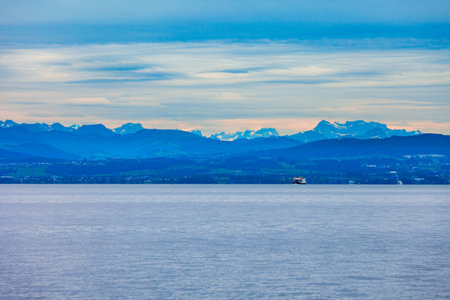 Alps mountains and Lake Constance or Bodensee Lake, view from Friedrichshafen, a city in Bavaria, Germany.の写真素材