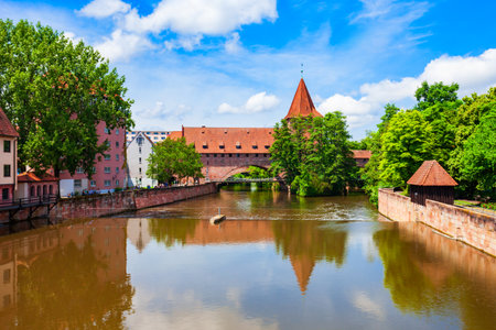 Fronveste bridge through Pegnitz river and Schlayerturm tower in Nuremberg old town. Nuremberg is the second largest city of Bavaria state in Germany.の写真素材
