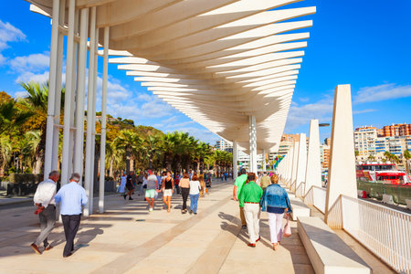 Malaga, Spain - October 23, 2021: Paseo del Muelle Uno boardwalk is a popular pedestrian promenade located in the centre of the city of Malagaのeditorial素材