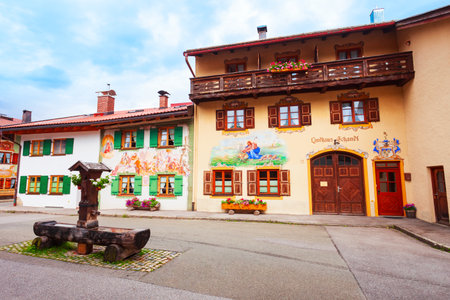 Mittenwald, Germany - July 01, 2021: Beauty local houses decorated with Luftlmalerei, bayern art form of facade painting in Mittenwald town in Bavaria, Germanyのeditorial素材