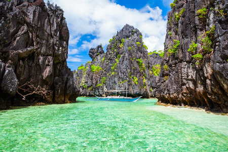 Traditional filipino boat bangka or banca at the blue lagoon in El Nido province, Palawan island in Philippinesの写真素材