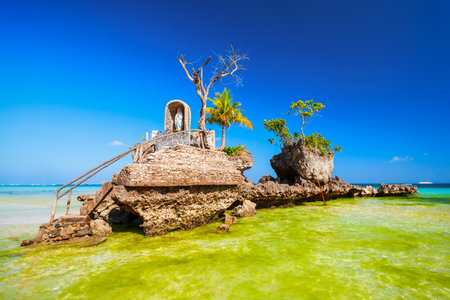 Willys Rock is a tidal island with a statue of the Virgin Mary at the Boracay beach in Philippinesの写真素材