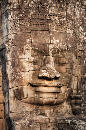 Stone Faces at Bayon Temple. Bayon is a well known khmer temple at Angkor in Cambodia.の写真素材