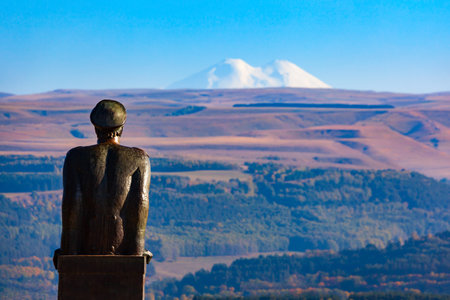 Kislovodsk, Russia - September 29, 2020: Mikhail Lermontov Monument at Krasnoye Solnyshko mountain viewpoint in Kislovodsk National Park and Elbrus mountain in Russiaのeditorial素材