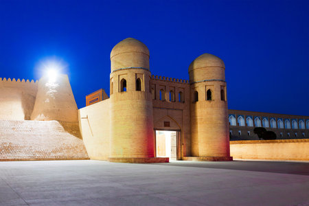 West Gate of the Itchan Kala, an ancient walled inner town of the city of Khiva in Uzbekistan at nightの写真素材