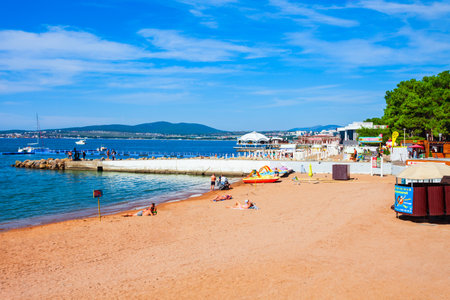 Gelendzhik, Russia - October 03, 2020: Gelenjik city beach with yellow sand. Gelendzhik is a resort town located on the Gelenjik Bay of the Black Sea in Krasnodar Krai, Russia.のeditorial素材