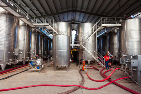 Kvareli, Georgia - September 03, 2021: Stainless steel storage tanks with wine in cellar of the Kindzmarauli Corporation Wineryのeditorial素材