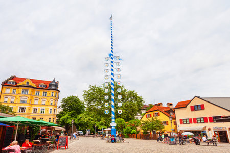 Munich, Germany - July 07, 2021: Traditional bavarian maypole with flag at the Wiener Platz square in Munich city in Bavaria, Germanyのeditorial素材