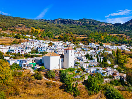 Our Lady of the Rosary Church aerial panoramic view in Bubion. Bubion is a village in the Alpujarras area in the province of Granada in Andalusia, Spain.の写真素材