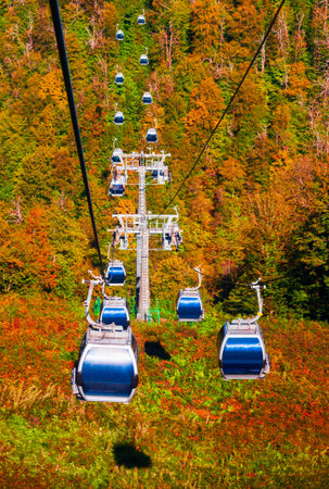Cable car cabin rises up from Rosa Khutor village to Roza Peak mountain in Sochi resort city in Krasnodar Krai, Russiaの写真素材