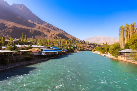 Ghunt river in Khorog city and Pamir mountains. Khorog is situated along the Pamir Highway in Gorno-Badakhshan, Tajikistan.の写真素材