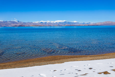 Beauty Karakul lake. Karakul or Qarokul lake is located in the Pamir Mountains near the border with China and Kyrgyzstan in Murghab region in Tajikistan.の写真素材