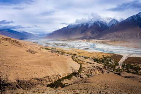 Panj river with Hindu Kush and Karakoram mountains in the Wakhan Corridor, border between Badakhshan province of Afghanistan and Pamir highway region in Tajikistan.の写真素材