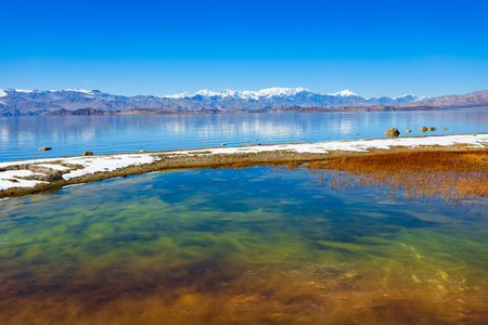 Beauty Karakul lake. Karakul or Qarokul lake is located in the Pamir Mountains near the border with China and Kyrgyzstan in Murghab region in Tajikistan.の写真素材